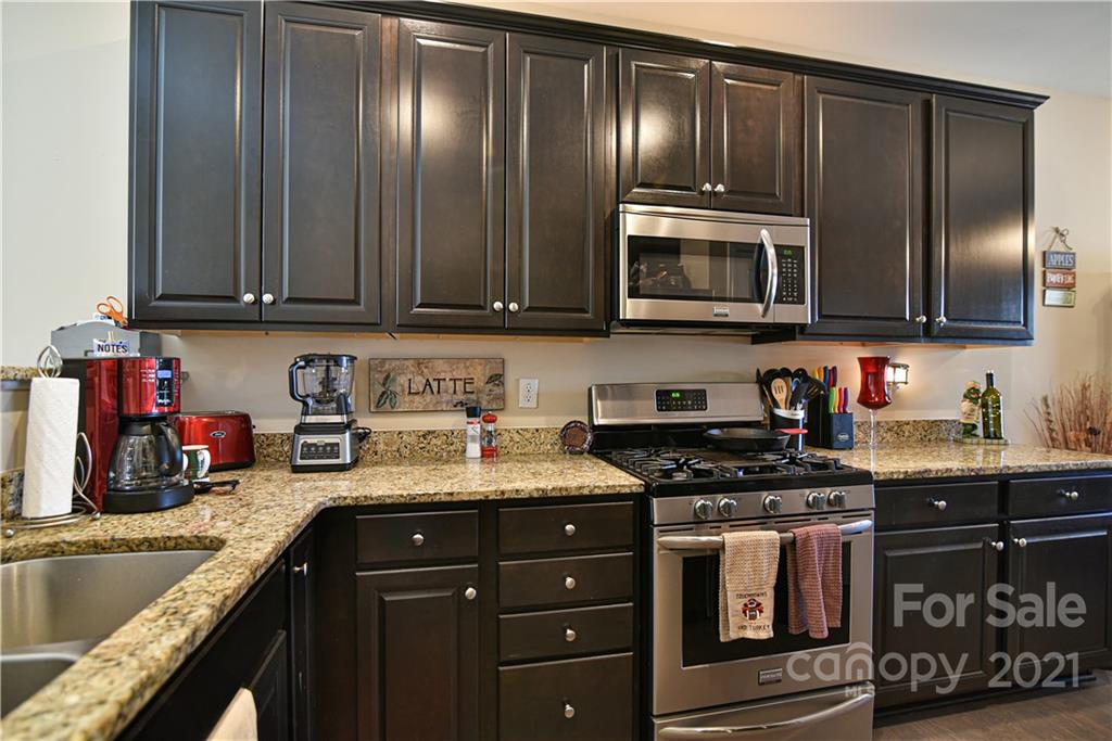 74 North River Road Fletcher, NC 28732 - Photo 7 of 29 a kitchen with granite countertop stainless steel appliances and cabinets
