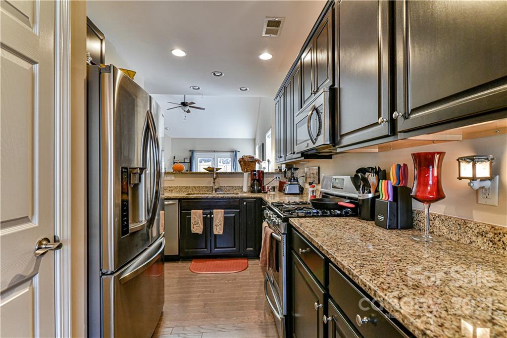 74 North River Road Fletcher, NC 28732 - Photo 8 of 29 a kitchen with stainless steel appliances granite countertop a refrigerator a sink and a stove
