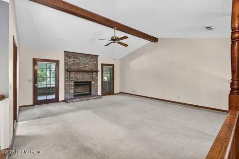 a view of empty room with fireplace