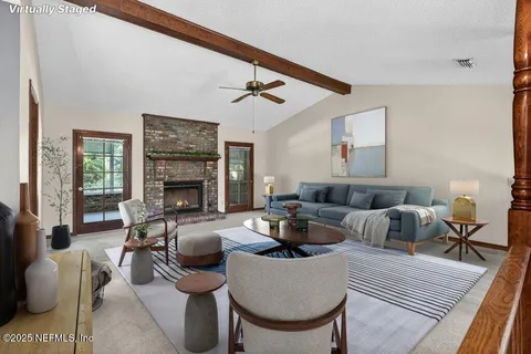 a living room with furniture and a fireplace