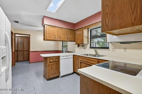 a kitchen with stainless steel appliances granite countertop a sink and a stove