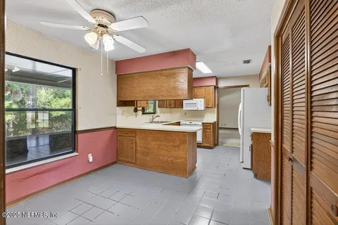 a kitchen with stainless steel appliances a sink and a refrigerator
