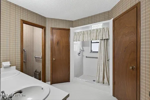 a bathroom with a shower and a sink