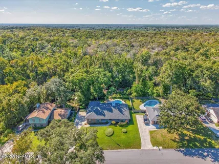 an aerial view of a house with a yard basket ball court and outdoor seating