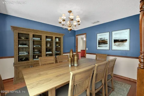 a dining room with furniture and chandelier