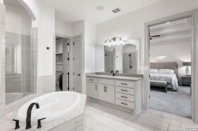 a white bath tub sitting next to a bathroom sink