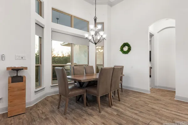 a view of a dining room with furniture and a chandelier