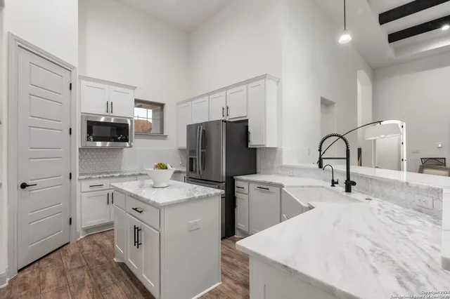 a kitchen with a sink stainless steel appliances and cabinets