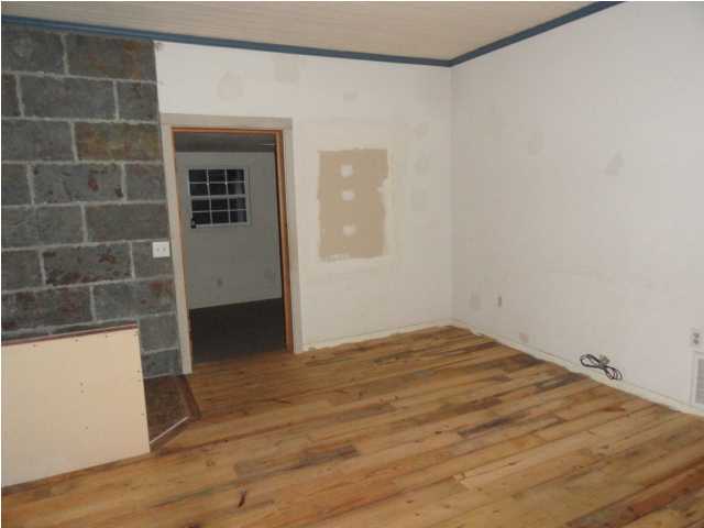 1121 Lighthouse Church Road Baker, FL 32531 - Photo 10 of 16 a view of empty room with wooden floor and fan