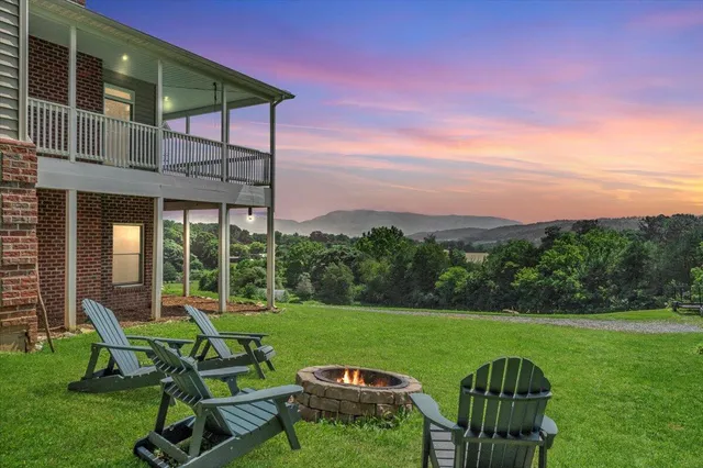 a front view of a house with a garden and trees