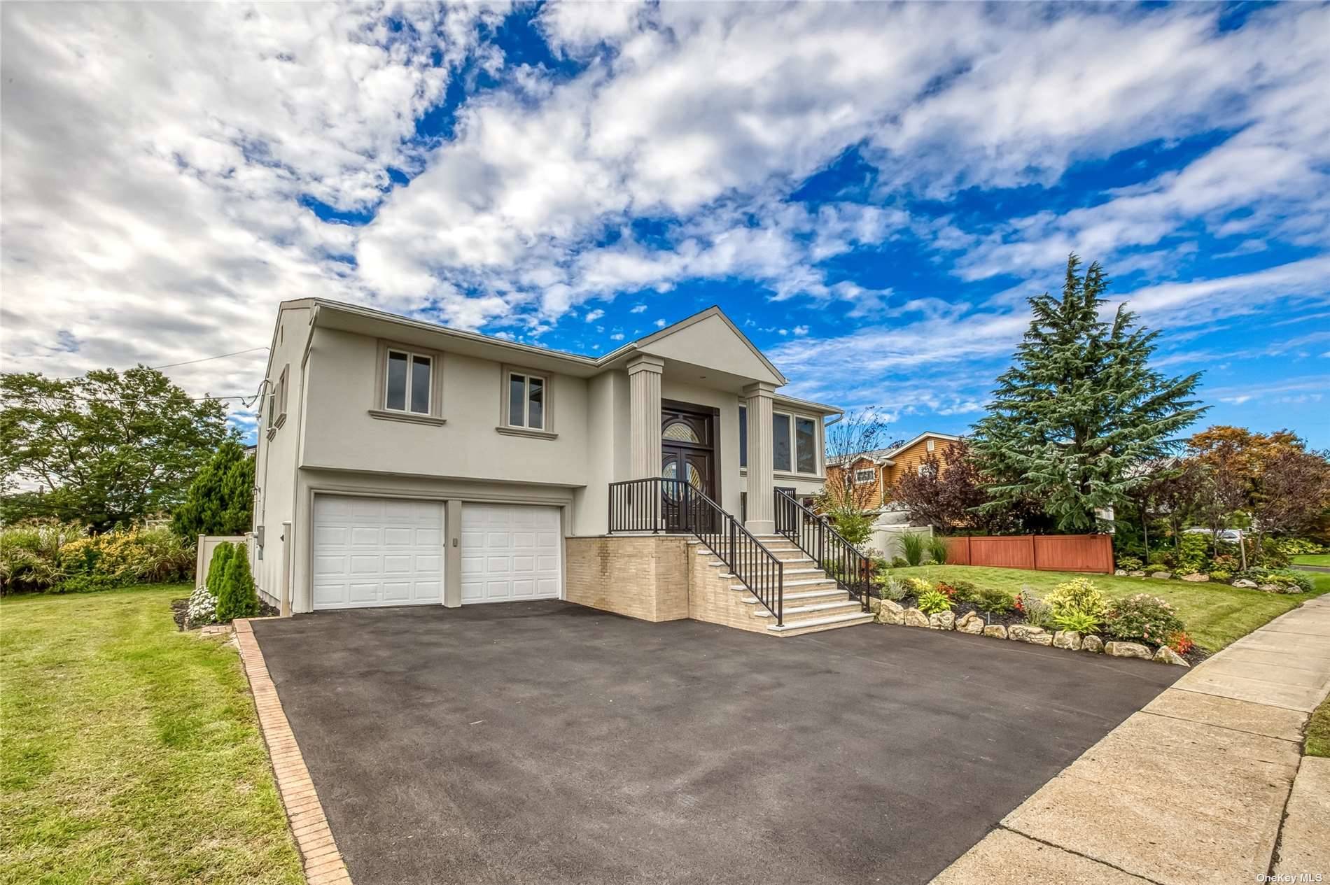2968 Judith Drive Bellmore, NY 11710 - Photo 1 of 1 a view of a white house next to a yard with plants and trees