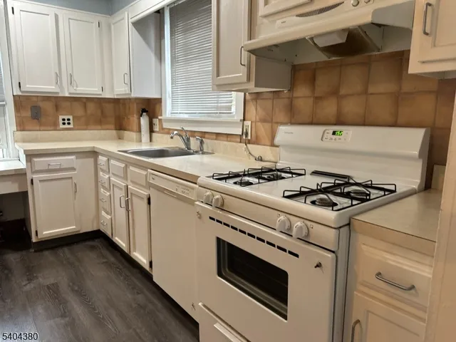 a kitchen with cabinets and appliances