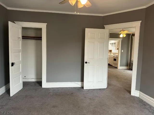 an empty room with closet and a bathroom