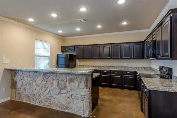 a kitchen with wooden cabinets and a sink