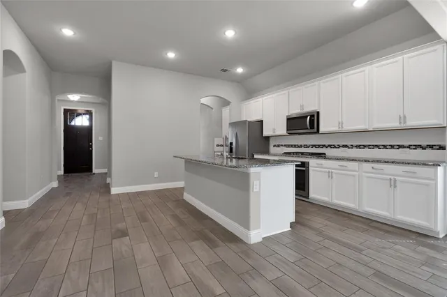 a kitchen with cabinets oven a sink and dishwasher