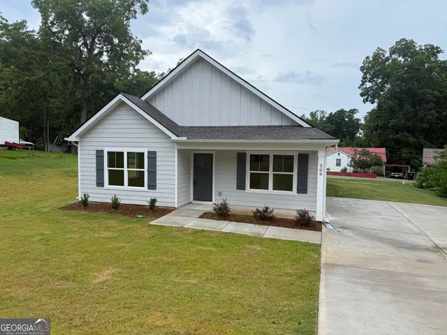 a front view of a house with a yard and porch