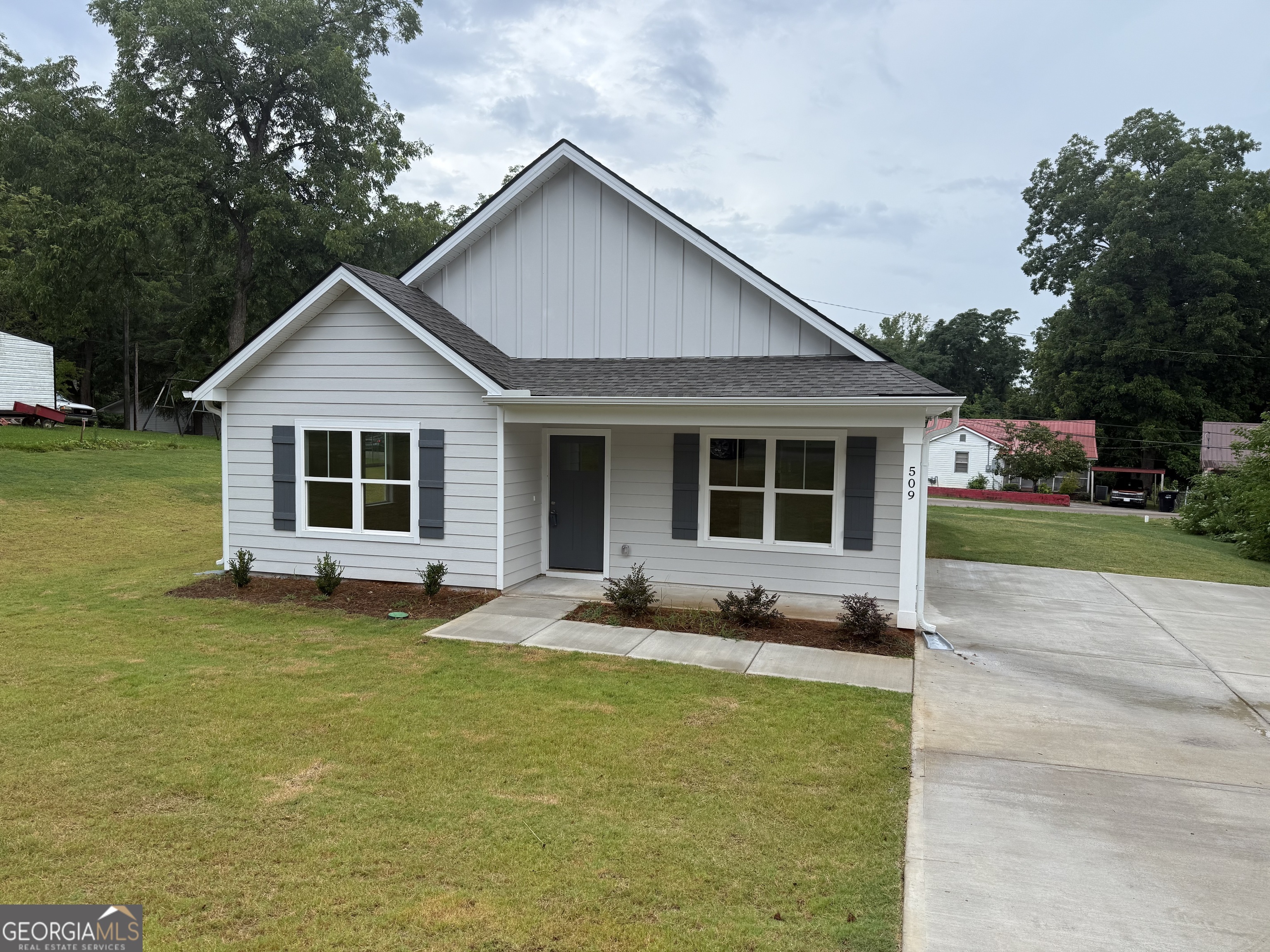 a front view of a house with a yard and porch