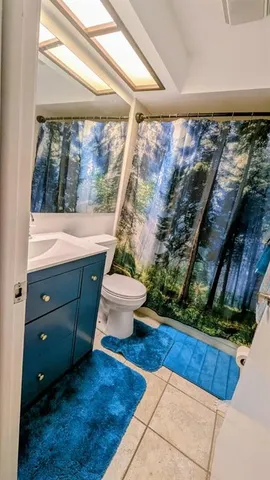 a living room with a toilet and a floor to ceiling window