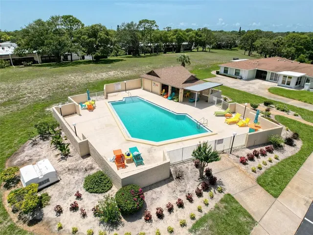 an aerial view of a house with a big yard