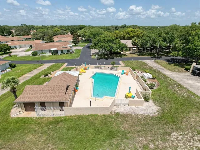 an aerial view of a house with a garden and lake view