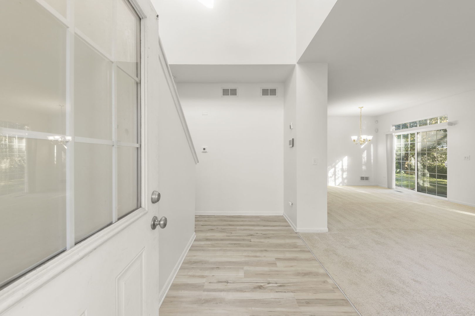 274 South Oak Creek Lane Romeoville, IL 60446 - Photo 2 of 19 a view of a hallway view with wooden floor and staircase