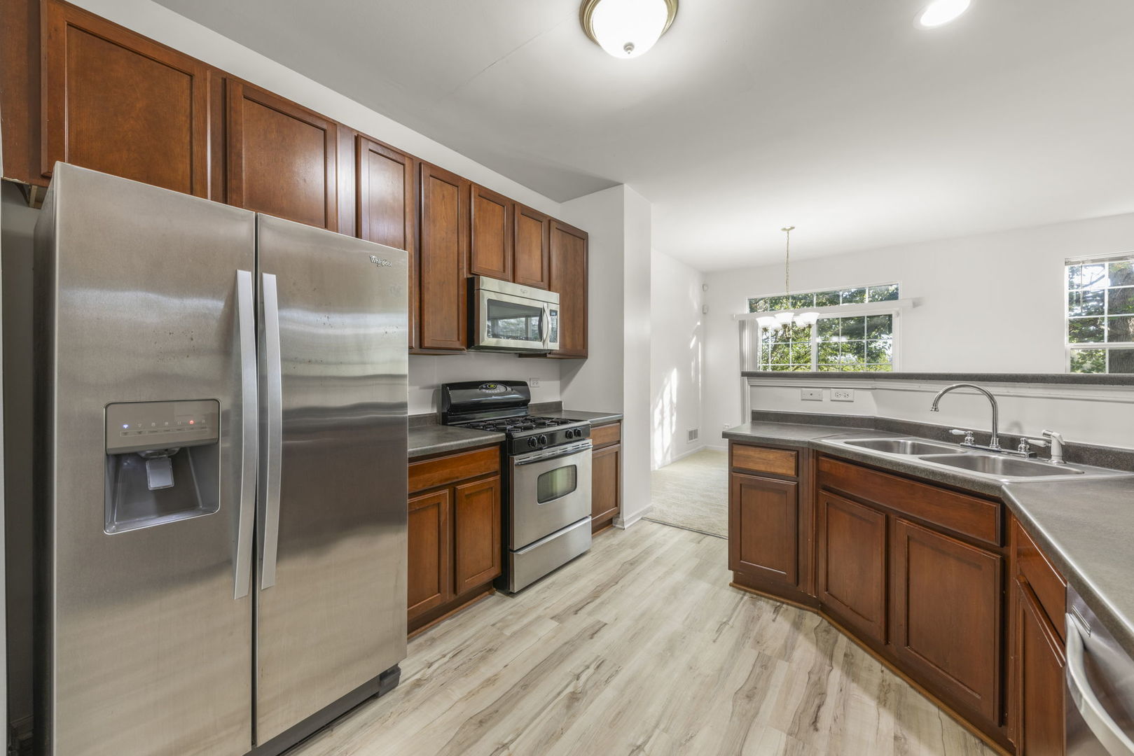 274 South Oak Creek Lane Romeoville, IL 60446 - Photo 8 of 19 a kitchen with stainless steel appliances granite countertop a refrigerator a stove and a sink