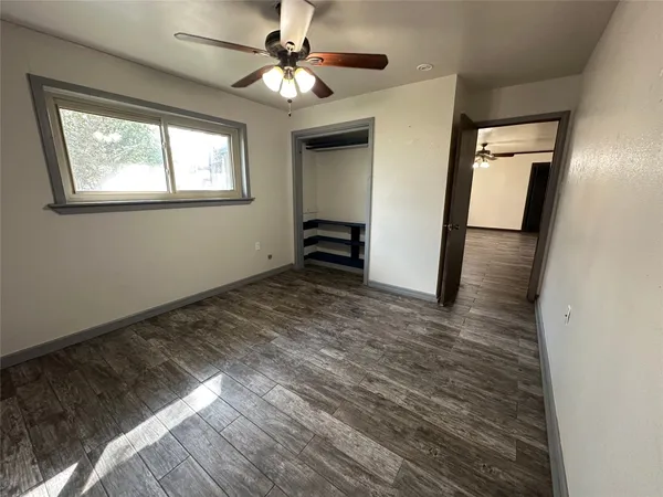 a view of a livingroom with a ceiling fan and window