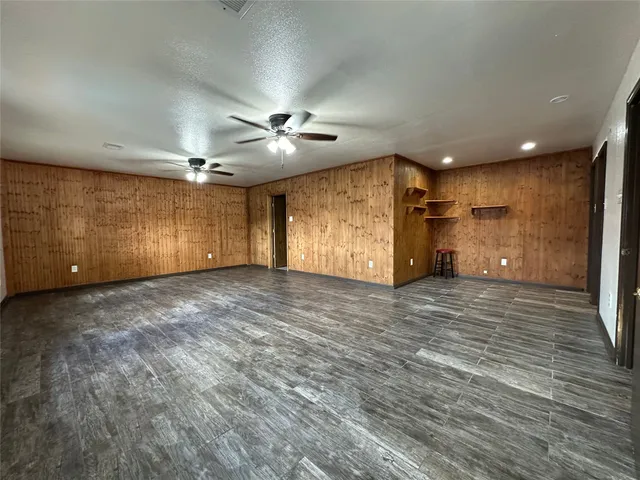a view of a livingroom with a ceiling fan window and wooden floor
