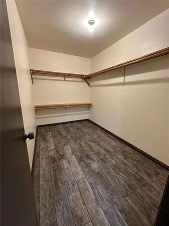 a view of a room with wooden floor and window