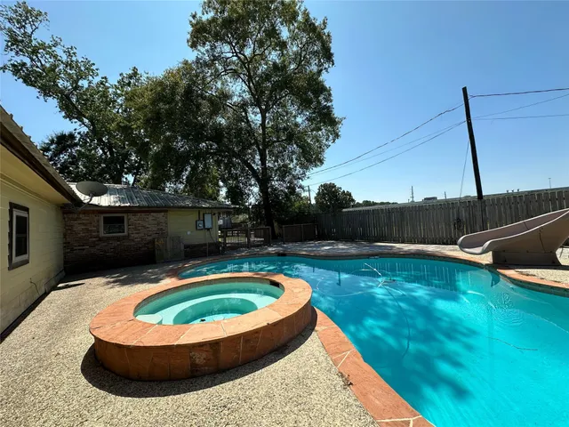 a view of a swimming pool with an outdoor
