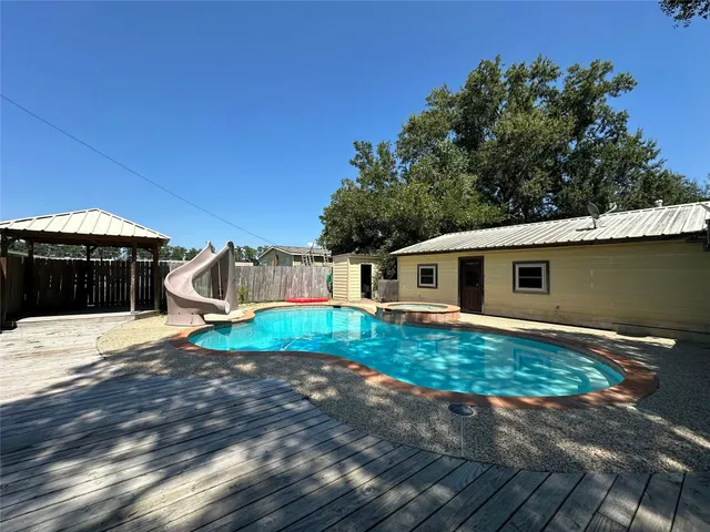 a view of a swimming pool with a yard