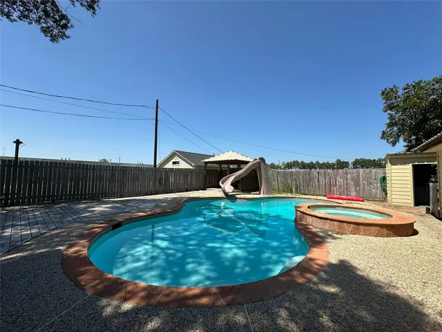 a view of a backyard with large trees