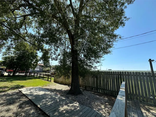 a view of swimming pool with a backyard and couches chairs