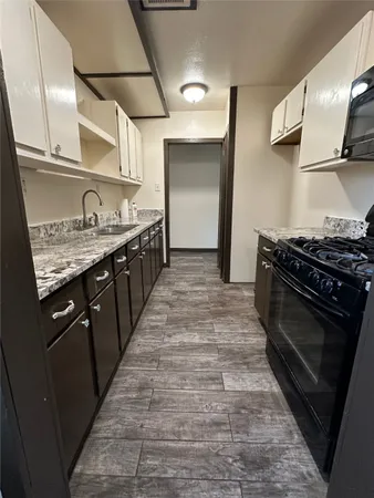 a kitchen with stainless steel appliances granite countertop a stove and a sink