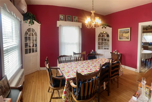 a view of a dining room with furniture and chandelier