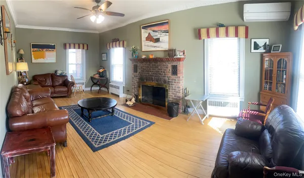 a living room with furniture a table and a fireplace