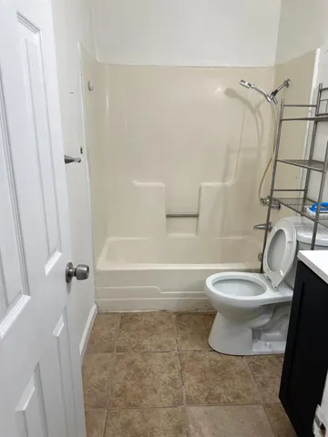 a bathroom with a toilet and a shower