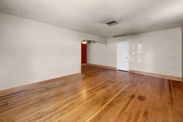 a view of an empty room and wooden floor