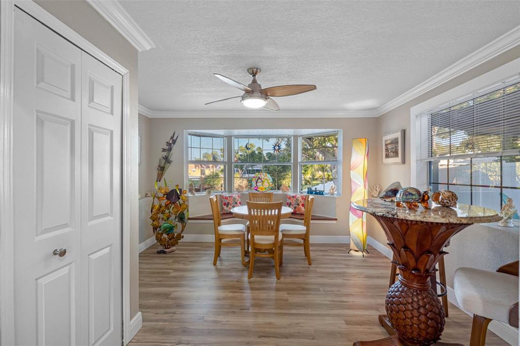 8139 129th Lane Seminole, FL 33776 - Photo 11 of 48 a dining room with furniture wooden floor and a chandelier