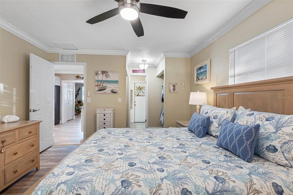 8139 129th Lane Seminole, FL 33776 - Photo 14 of 48 a bedroom with a large bed and a chandelier