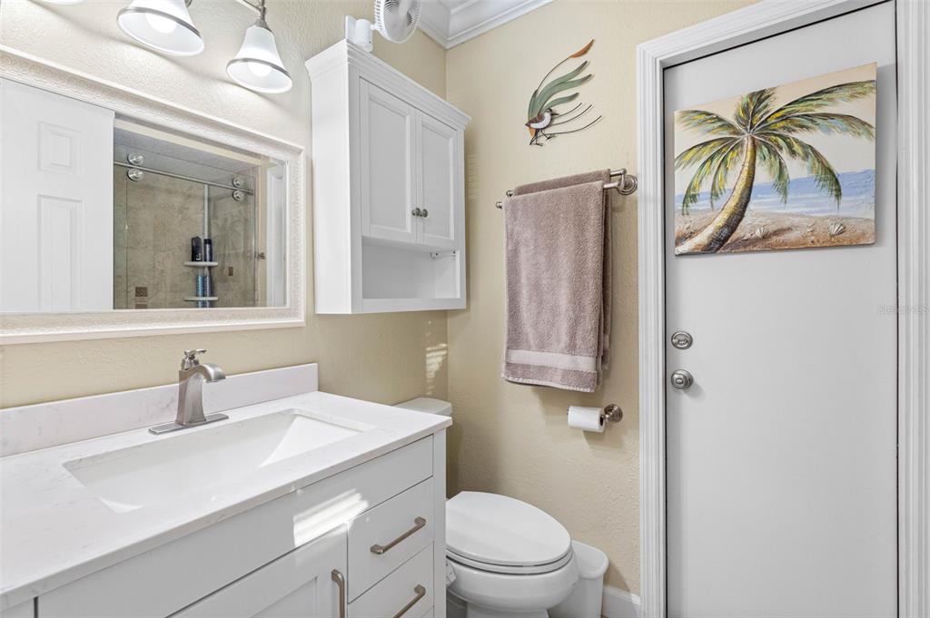 8139 129th Lane Seminole, FL 33776 - Photo 16 of 48 a bathroom with a sink a toilet and a mirror