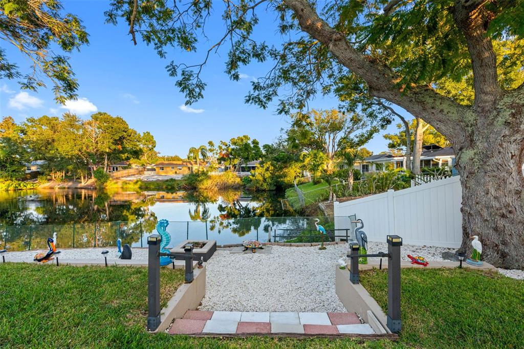 8139 129th Lane Seminole, FL 33776 - Photo 33 of 48 a view of a backyard with a garden and trees