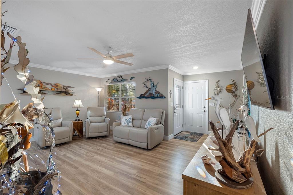 8139 129th Lane Seminole, FL 33776 - Photo 6 of 48 a living room with furniture or chandelier and a wooden floor