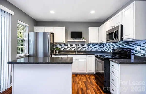 a kitchen with stainless steel appliances a stove sink and microwave