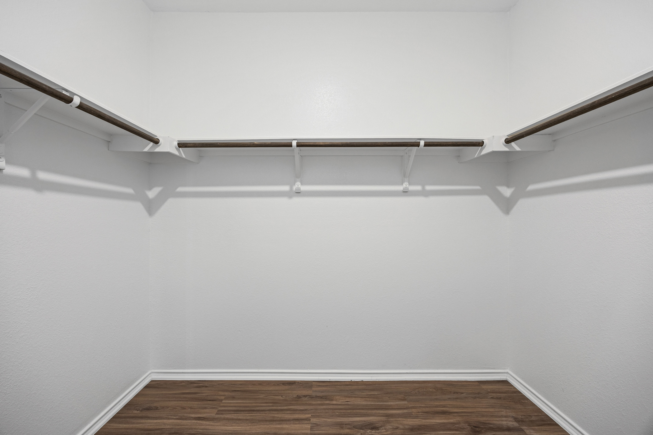1609 Woolsey Way Leander, TX 78641 - Photo 8 of 29 Walk in closet featuring dark wood-style flooring