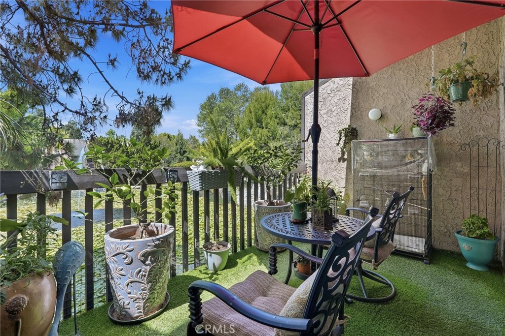 7890 East Spring Street, Unit 2L Long Beach, CA 90815 - Photo 9 of 47 a backyard of a house with table and chairs