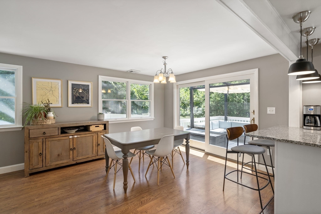 26 Miller Road Easton, MA 02356 - Photo 12 of 29 a dining room with wooden floor a chandelier a wooden table and chairs
