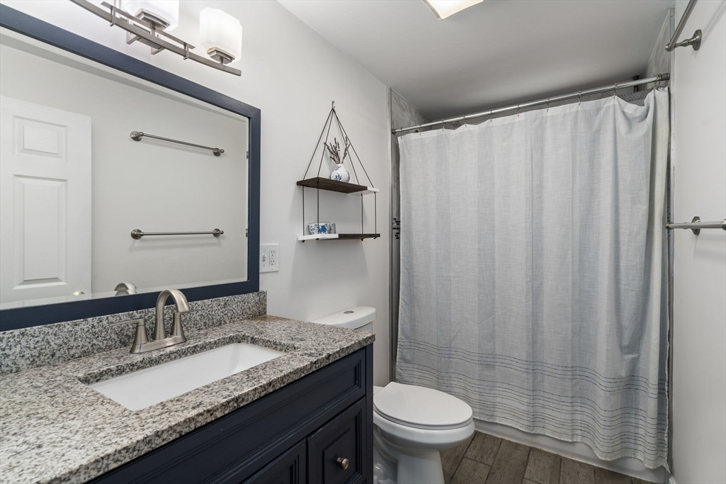 26 Miller Road Easton, MA 02356 - Photo 19 of 29 a bathroom with a granite countertop sink and a mirror