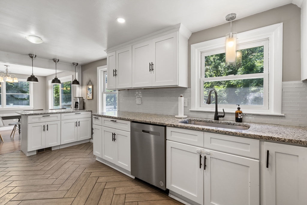 26 Miller Road Easton, MA 02356 - Photo 9 of 29 a kitchen with granite countertop white cabinets white appliances a sink and a window
