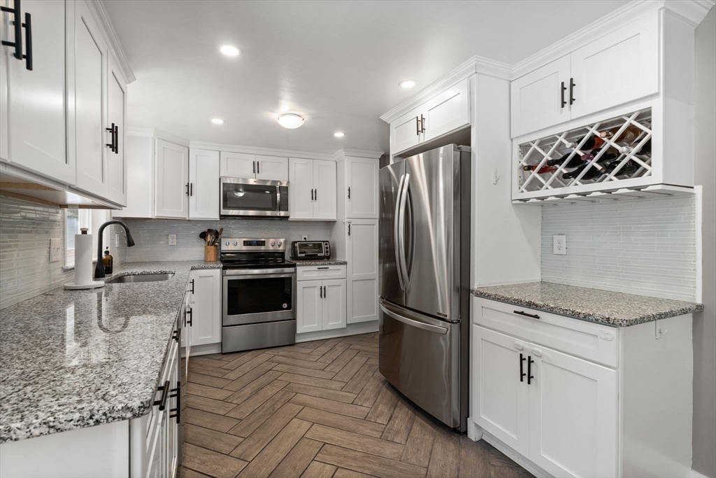 26 Miller Road Easton, MA 02356 - Photo 10 of 29 a kitchen with granite countertop a refrigerator and a sink